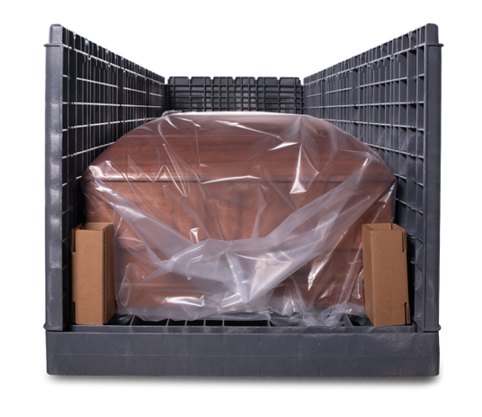 The end view of a packaged wood casket inside a plastic oversize vault ready for shipment or storage