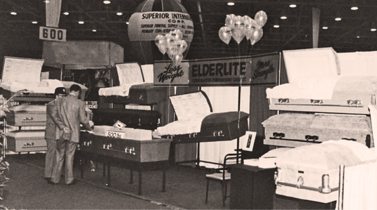 Vintage photo of Elderlite caskets displayed in a trade show booth.