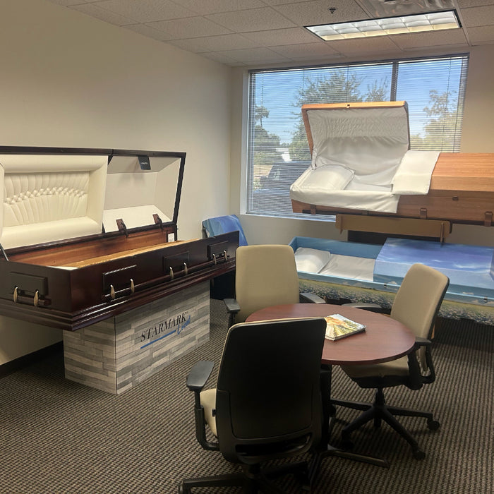 Starmark Southwest Showroom with casket and cremation containers on display and meeting table in the center of the room.