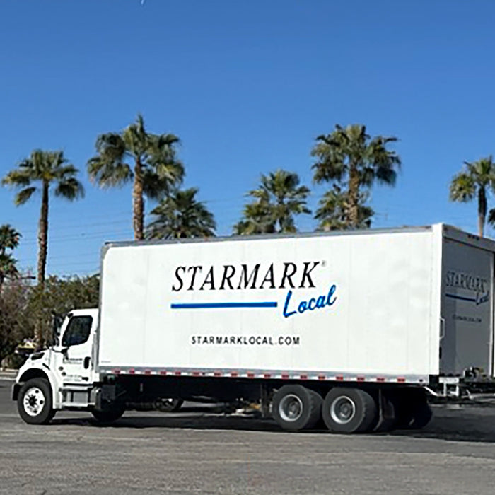 Starmark Local Box truck with palm trees in the background